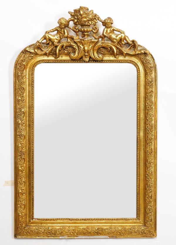 A VICTORIAN GILT FRAMED WALL MIRROR WITH CHERUB MOUNTED CREST (2)