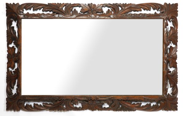 A RECTANGULAR MIRROR WITH SWEPT FOLIATE CARVED OAK FRAME