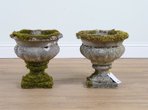 A PAIR OF RECONSTITUTED STONE GARDEN URNS (2)