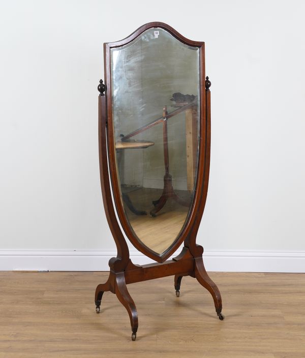 AN EDWARDIAN MAHOGANY FRAMED SHIELD SHAPED CHEVAL MIRROR