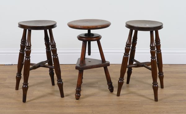 A PAIR OF STAINED BEECH AND ASH TOPPED STOOLS AND A 19TH CENTURY OAK HEIGHT ADJUSTABLE CIRCULAR STOOL (3)