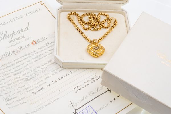 A CHOPARD 'HAPPY DIAMONDS' GOLD HEART PENDANT AND CHAIN