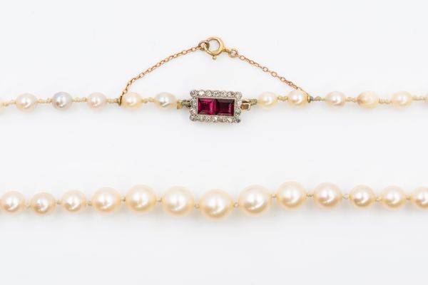 A SINGLE ROW OF PEARLS WITH A RUBY AND DIAMOND CLASP