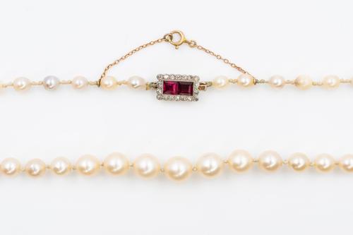 A SINGLE ROW OF PEARLS WITH A RUBY AND DIAMOND CLASP