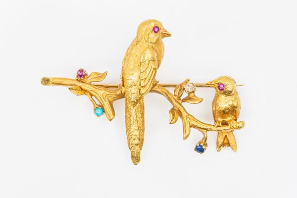 A GEMSET GOLD BIRD BROOCH