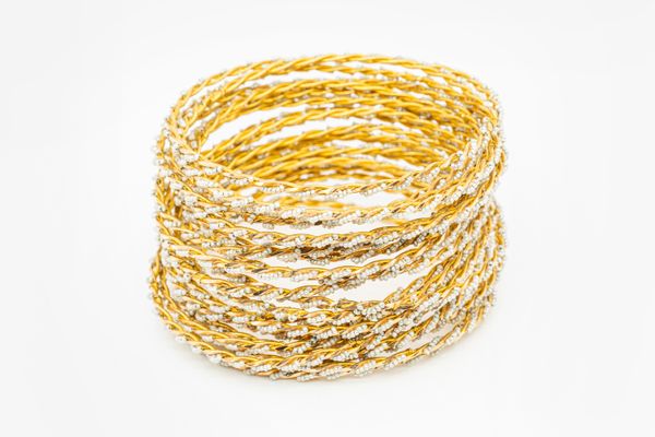 TWENTY-FOUR GOLD AND SEED PEARL BANGLES