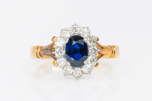 A SAPPHIRE AND DIAMOND CLUSTER RING