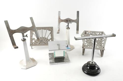 A LARGE GROUP OF MID 20TH CENTURY METAL STANDS INCLUDING WIG STANDS, BOOK STANDS AND OTHERS.