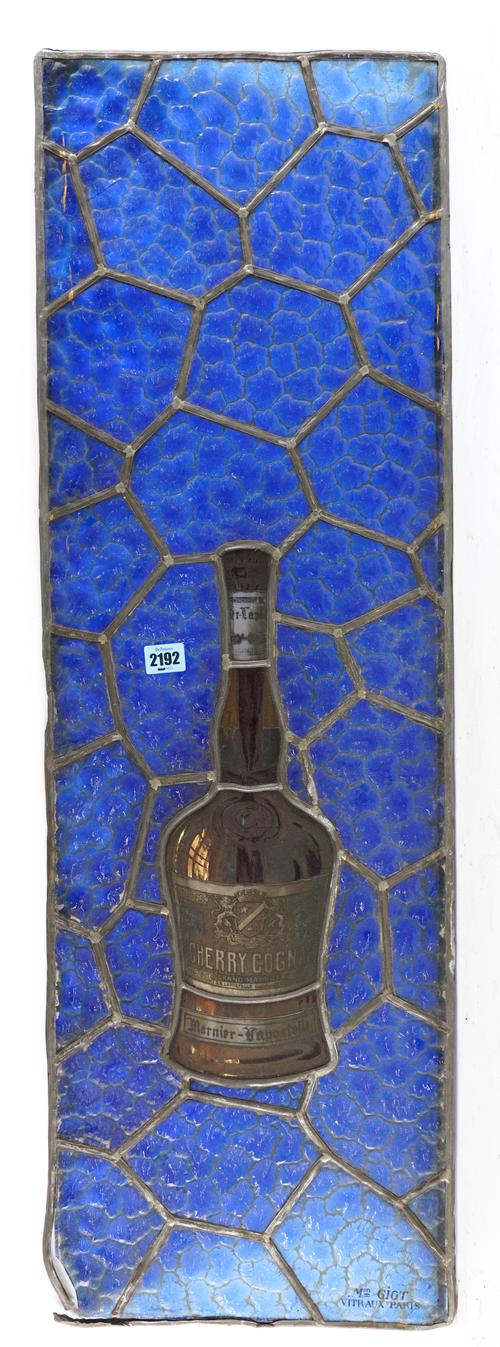 A PAIR OF LEADED AND STAINED GLASS WINDOWS, ONE DEPICTING A BOTTLE OF COGNAC