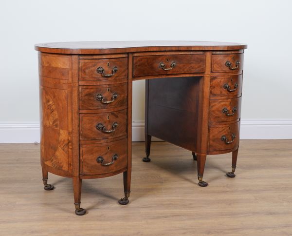 AN EDWARDIAN MAHOGANY KIDNEY SHAPED WRITING DESK