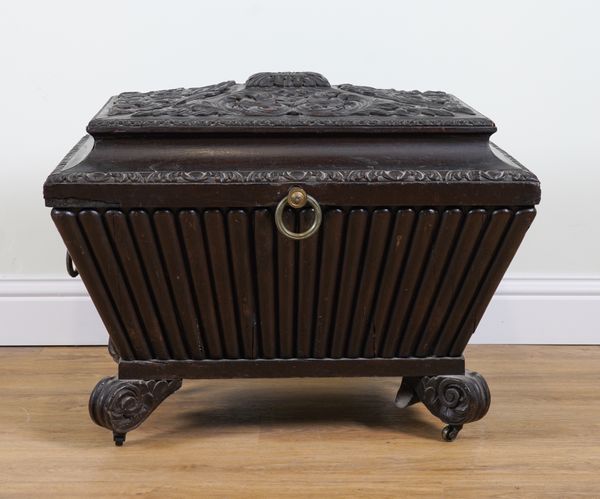 A GEORGE IV CARVED MAHOGANY AND LATER PAINTED SARCOPHAGUS SHAPED CELLARETTE