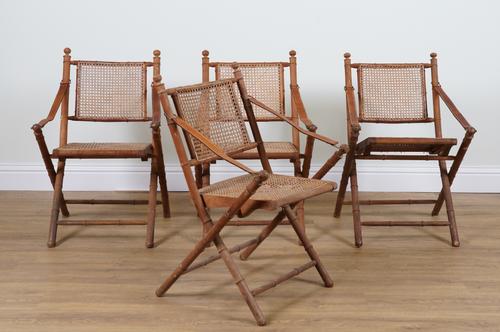 A SET OF FOUR BAMBOO AND CANE WORK FOLDING ARMCHAIRS (4)