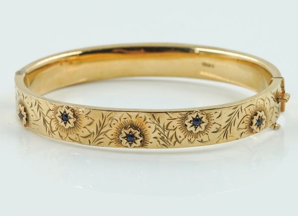 A VINTAGE GOLD BANGLE WITH SAPPHIRES