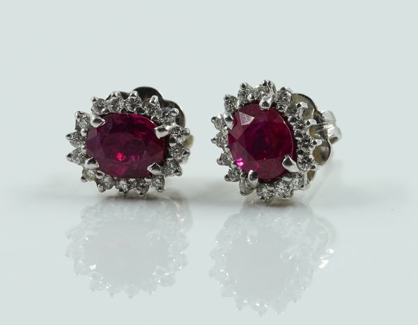 A PAIR OF WHITE GOLD, RUBY AND DIAMOND OVAL CLUSTER EARSTUDS