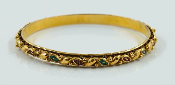 A GOLD ENAMEL BANGLE