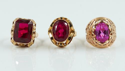 THREE SYNTHETIC GEMSTONE RINGS