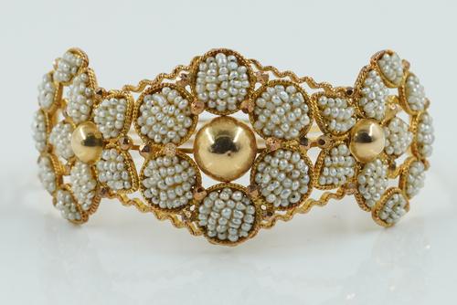 A GOLD AND SEED PEARL BANGLE