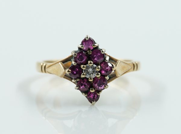 A 9CT GOLD, RUBY AND DIAMOND NINE STONE MARQUISE SHAPED CLUSTER RING