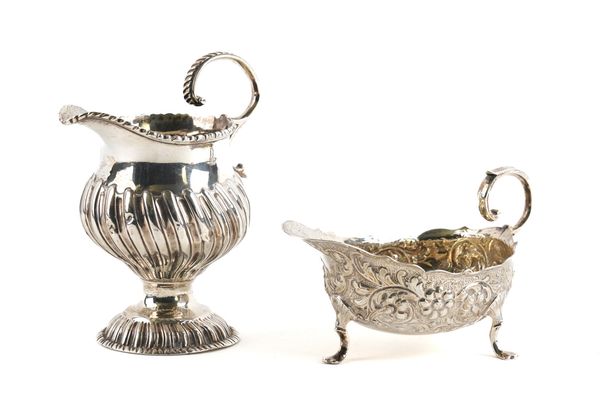 A GEORGE III SILVER CREAM JUG AND A VICTORIAN SILVER SAUCEBOAT (2)