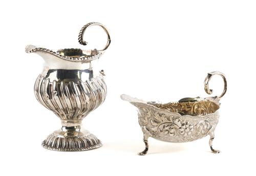 A GEORGE III SILVER CREAM JUG AND A VICTORIAN SILVER SAUCEBOAT (2)