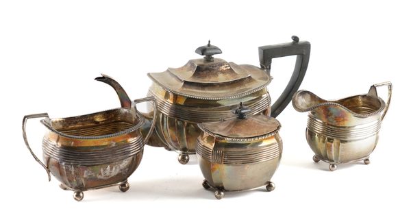 A SILVER THREE PIECE TEA SET AND A SILVER TEA CADDY (4)