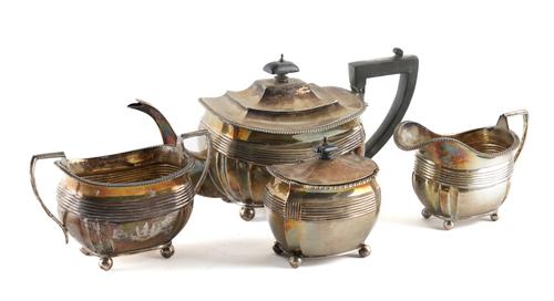 A SILVER THREE PIECE TEA SET AND A SILVER TEA CADDY (4)