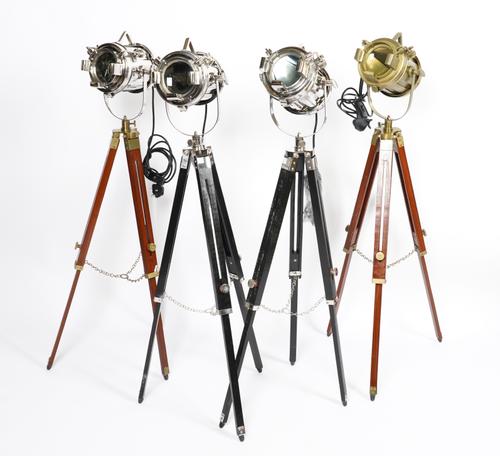 THREE CHROME-PLATED AND ONE BRASS-PLATED SPOT-LIGHTS ON TRIPOD STANDS (4)