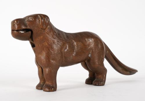 A BRONZE TABLE NUT CRACKER IN THE FORM OF A DOG