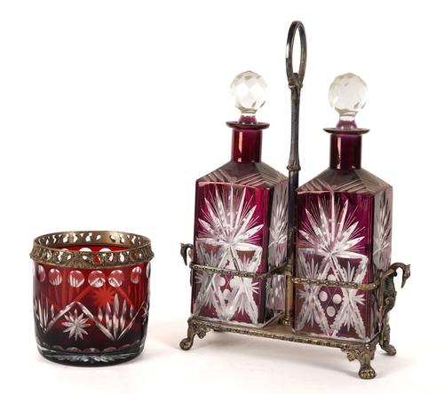 A PAIR OF RUBY COLOURED CUT GLASS DECANTERS ON STAND (2)