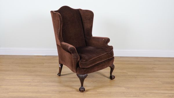 A VICTORIAN MAHOGANY FRAMED WINGBACK ARMCHAIR ON BALL AND CLAW FEET