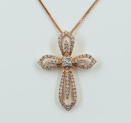 A GOLD AND DIAMOND PENDANT CROSS WITH A GOLD NECKCHAIN
