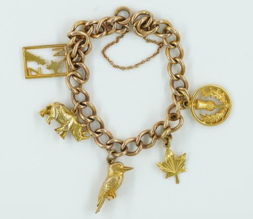 A 9CT GOLD CURB LINK CHARM BRACELET