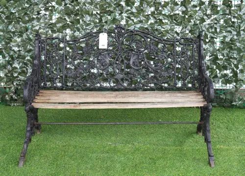 AN EARLY 20TH CENTURY BLACK PAINTED CAST IRON BENCH