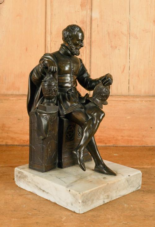 A BRONZE SEATED FIGURE ON A MARBLE PLINTH, POSSIBLY SIR FRANCIS DRAKE