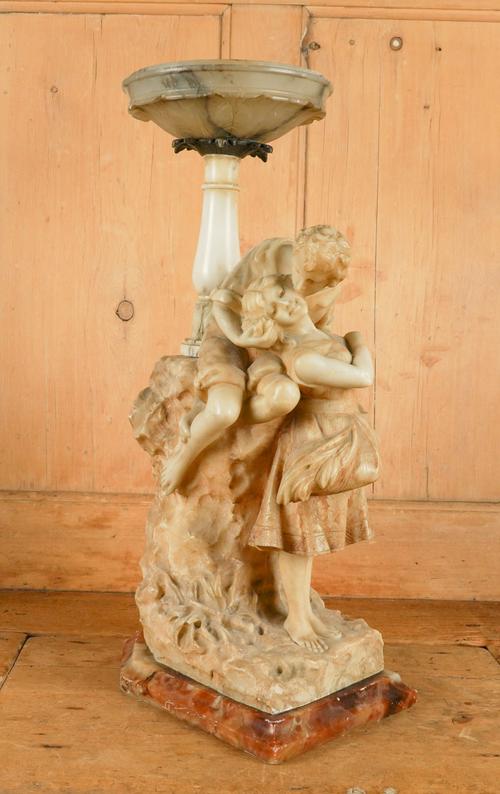 AN ALABASTER SCULPTURALGROUP OF AN AMOROUS COUPLE
