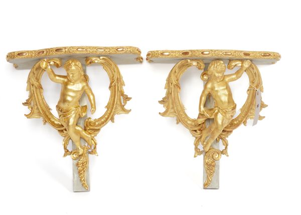 A PAIR OF GILT AND GREY DECORATED COMPOSITION AND PLASTER ROCCO STYLE WALL BRACKETS (2)