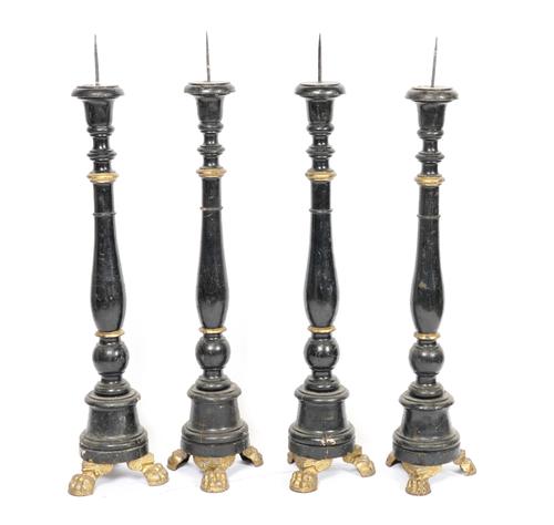 TWO PAIRS OF CONTINENTAL EBONISED AND PARCEL-GILT DECORATED PRICKET CANDLESTICKS (4)