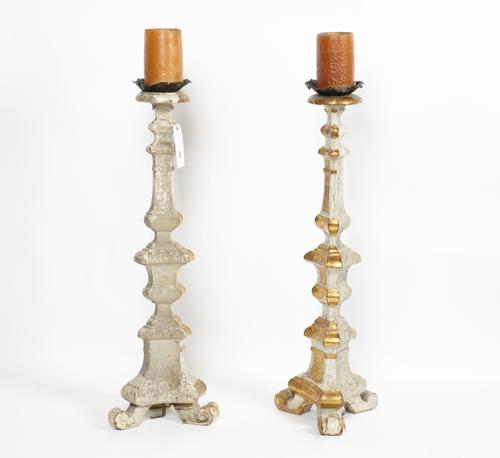 A PAIR OF BAROQUE STYLE PAINTED AND GILTWOOD ALTAR PRICKET CANDLESTICKS AND AN ITALIAN ROCOCO STYLE GILT BRASS FIVE LIGHT CANDELABRUM (3)