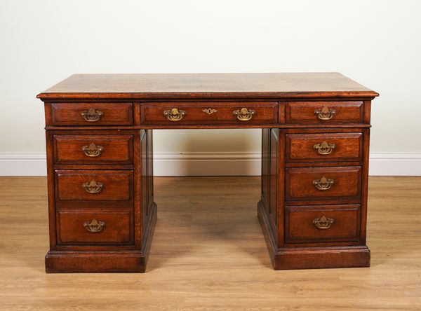 TITCHMARSH AND GOODWIN; AN OAK NINE DRAWER PEDESTAL DESK