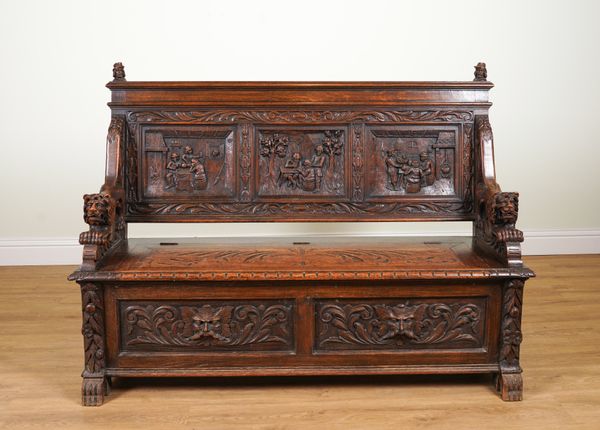 A VICTORIAN STYLE CARVED OAK SETTLE