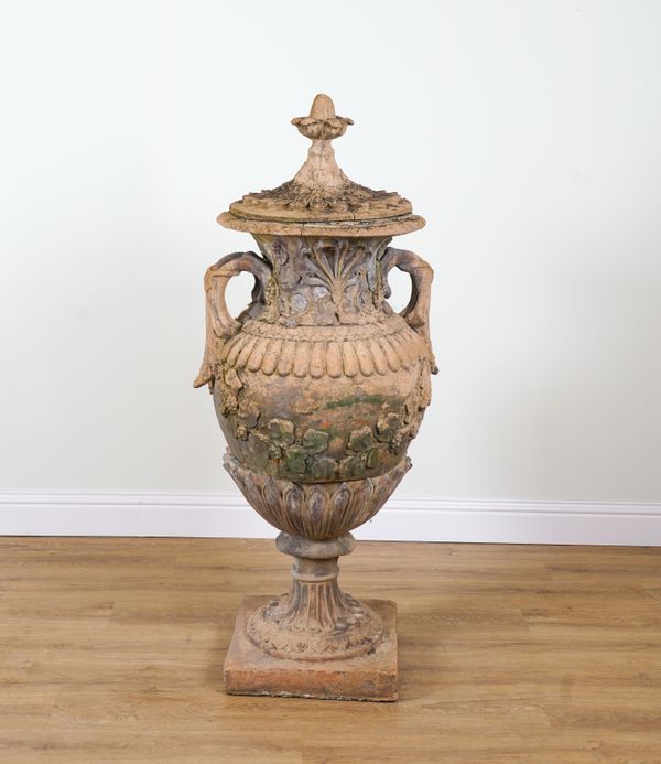 A PAIR OF SWEDISH STYLE COMPOSITION STONE LIDDED URNS (2)