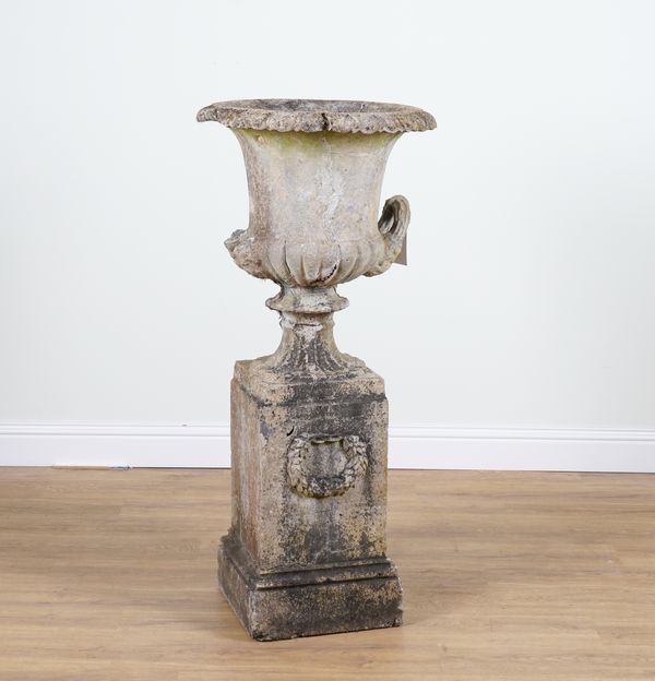 A LATE 19TH CENTURY COMPOSITION STONE URN ON PEDESTAL