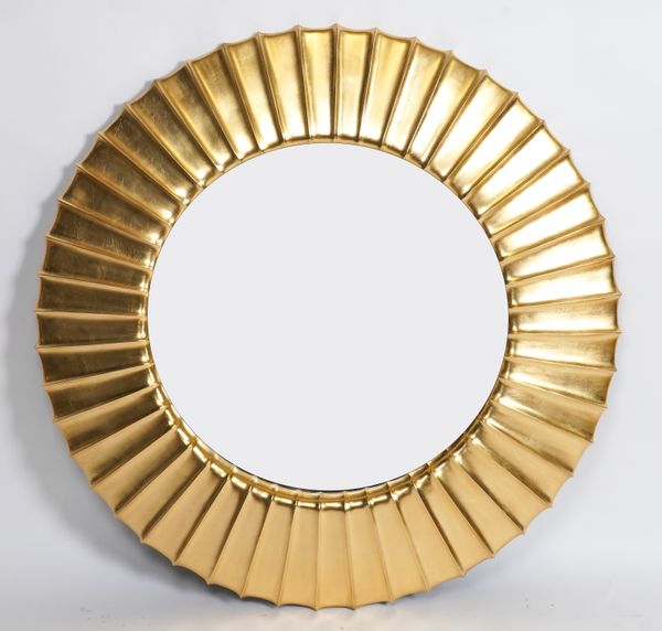 CHRISTOPHER GUY; A GOLD PAINTED CIRCULAR WALL MIRROR