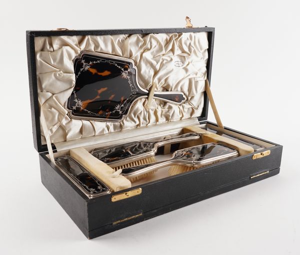 A SILVER MOUNTED TORTOISHELL SIX PIECE LADIES DRESSING SET