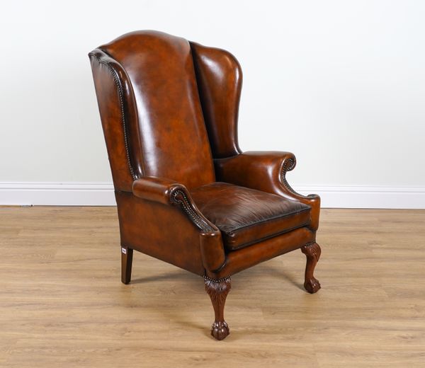 A VICTORIAN STYLE LEATHER UPHOLSTERED WINGBACK ARMCHAIR