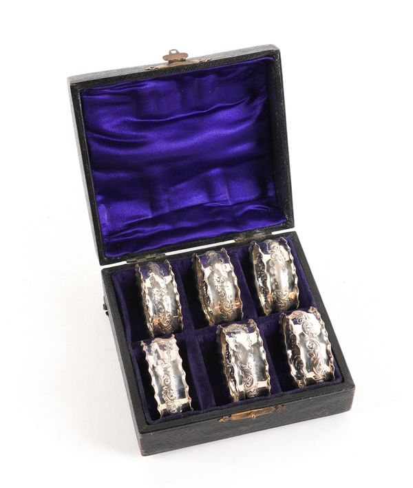 A SET OF SIX SILVER NAPKIN RINGS