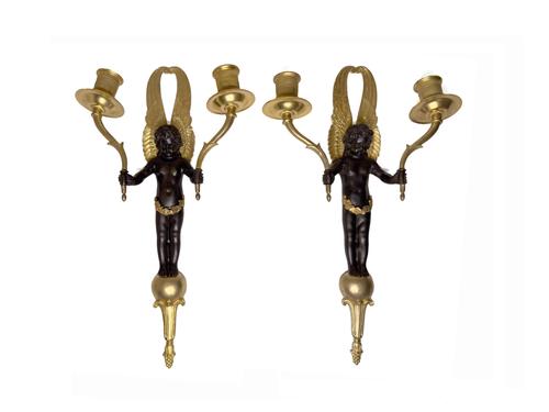 A PAIR OF EMPIRE STYLE GILT AND PATINATED METAL TWIN LIGHT WALL APPLIQUES (2)
