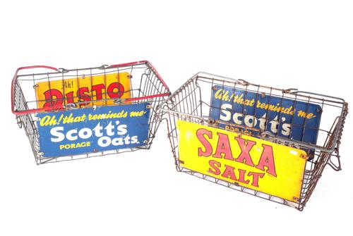 A PAIR OF MID 20TH CENTURY WIREWORK ADVERTISING SHOPPING BASKETS