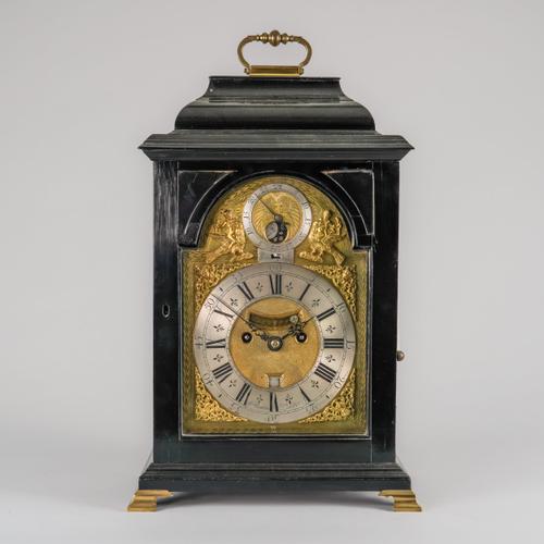 A GEORGE II EBONISED STRIKING AND QUARTER REPEATING BRACKET CLOCK WITH PENNY MOON