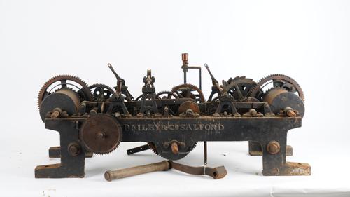 A BLACK-PAINTED CAST-IRON THREE-TRAIN TURRET CLOCK